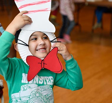 Child enjoying crafts prior to performance